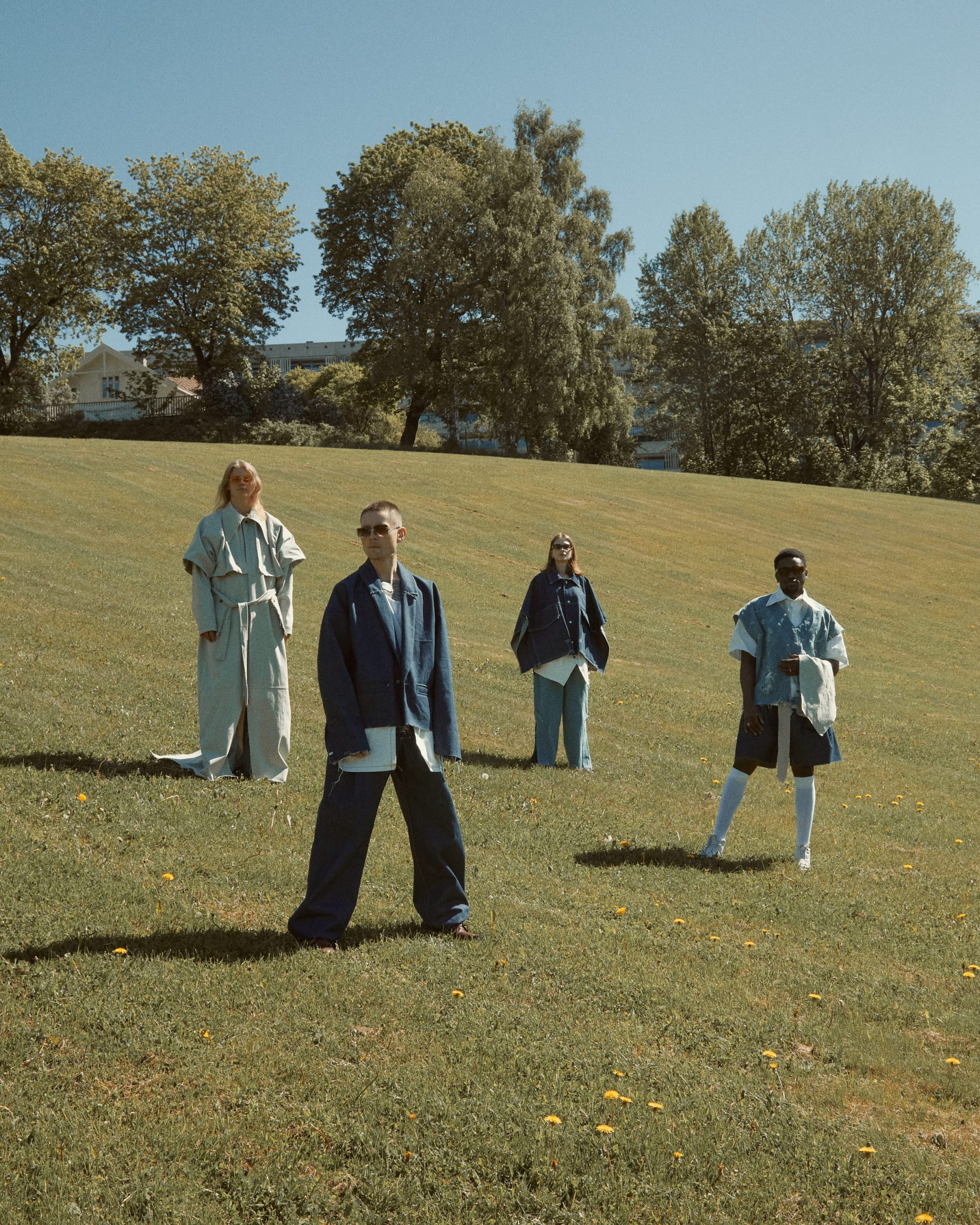 Group: Four people in full denim in a field
